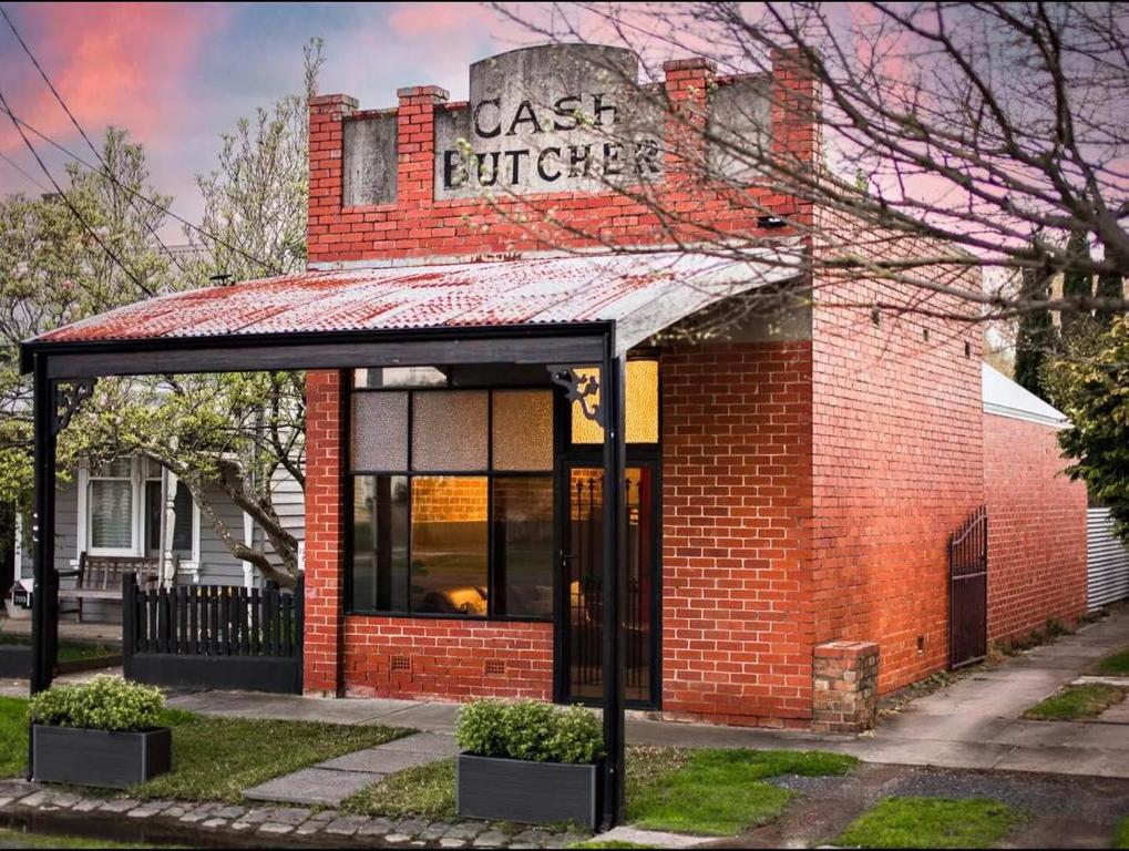 a red brick building with a sign on it at The Cash Butcher - Classy & Centrally Located in Ballarat