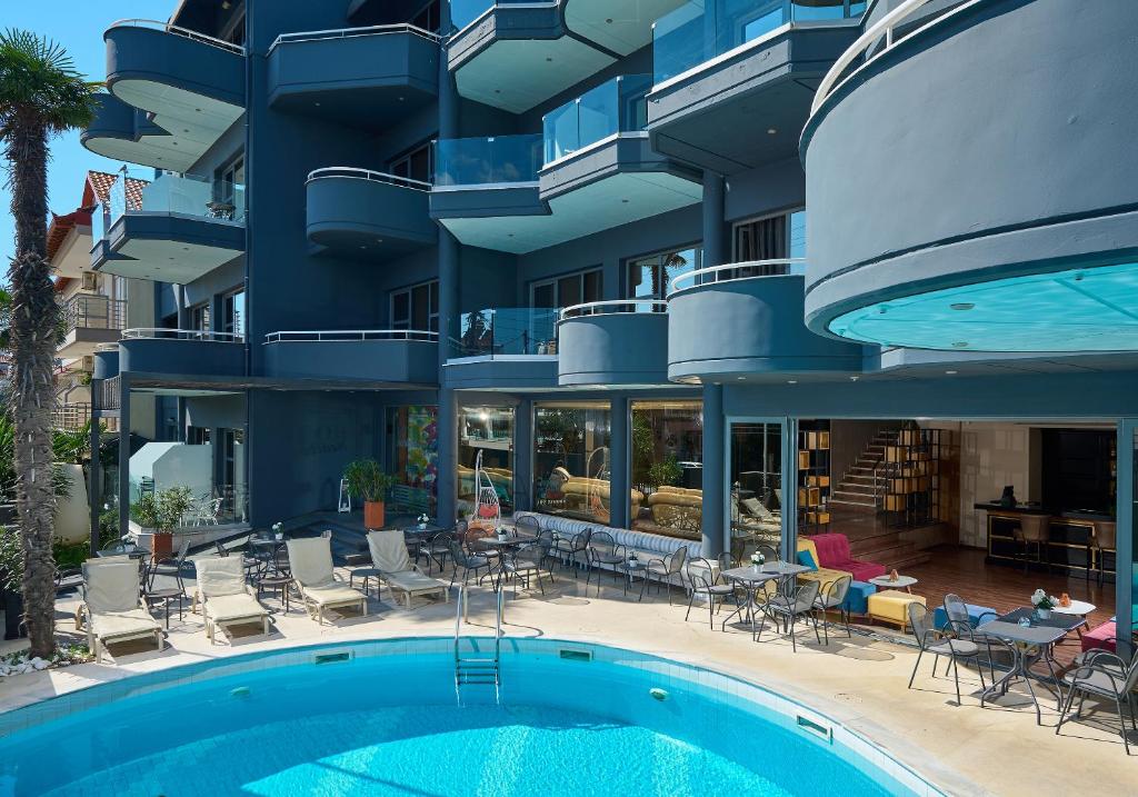an apartment building with a swimming pool in front of it at Mediterranean Resort in Paralia Katerinis