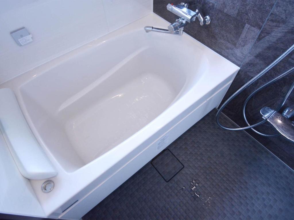 a white bath tub in a bathroom at Daigo - Vacation STAY 04186v in Kanayama