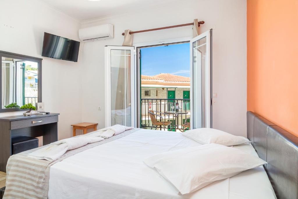 Postel nebo postele na pokoji v ubytování Vergina Star Hotel