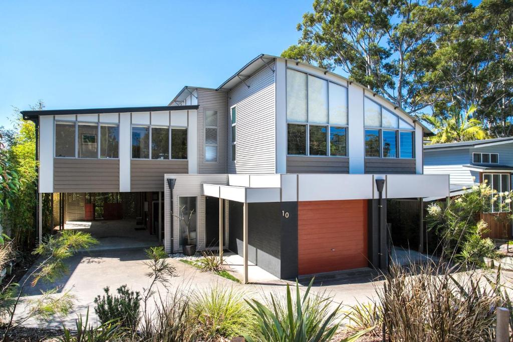 a large house with a lot of windows at Aurora in Mollymook