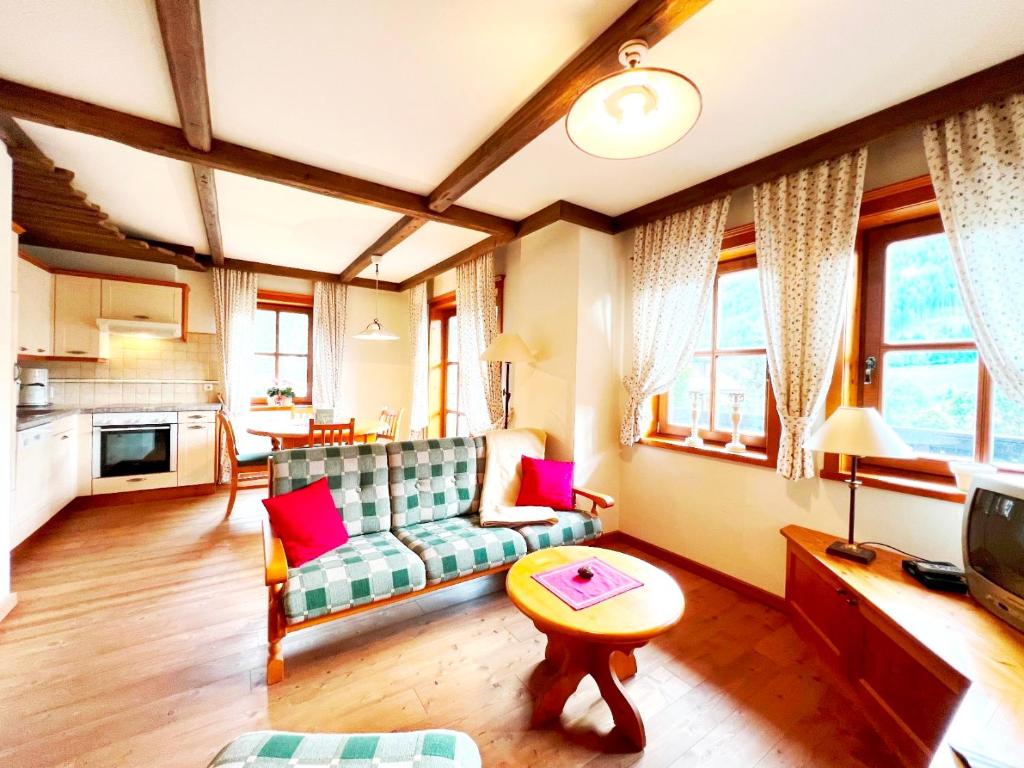 a living room with a couch and a table at Ferienwohnung Südblick in Bad Kleinkirchheim