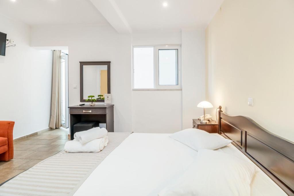 Postel nebo postele na pokoji v ubytování Vergina Star Hotel