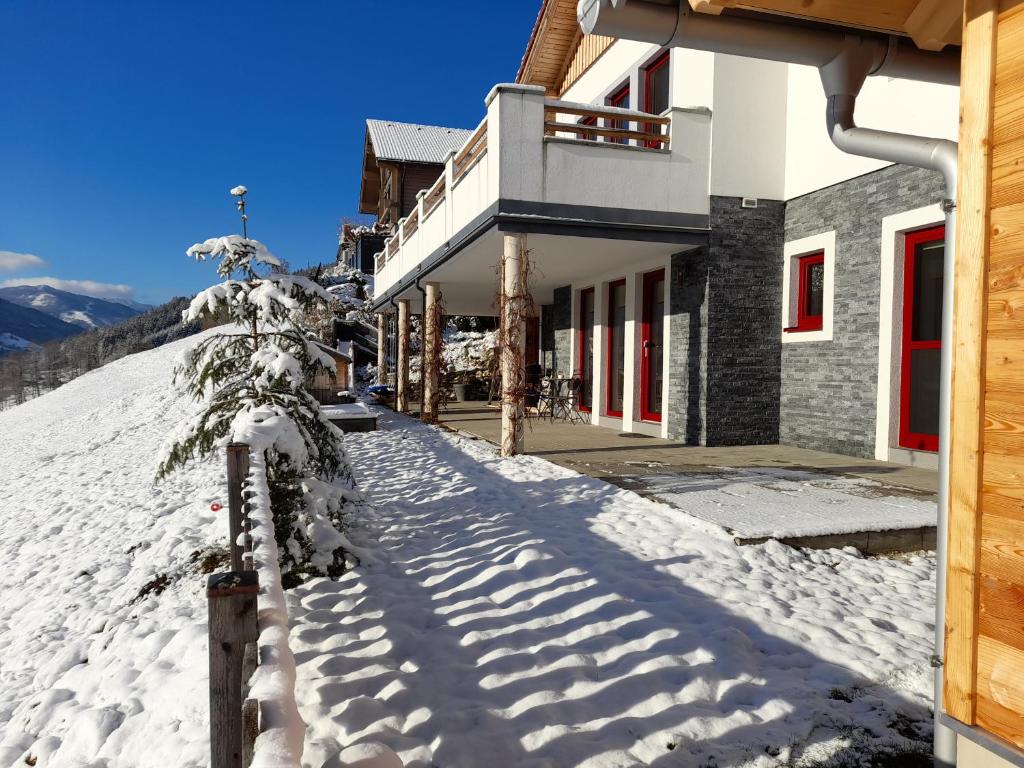 a building with snow on the side of it at Ferienwohnung Sunnseitn in Haus im Ennstal