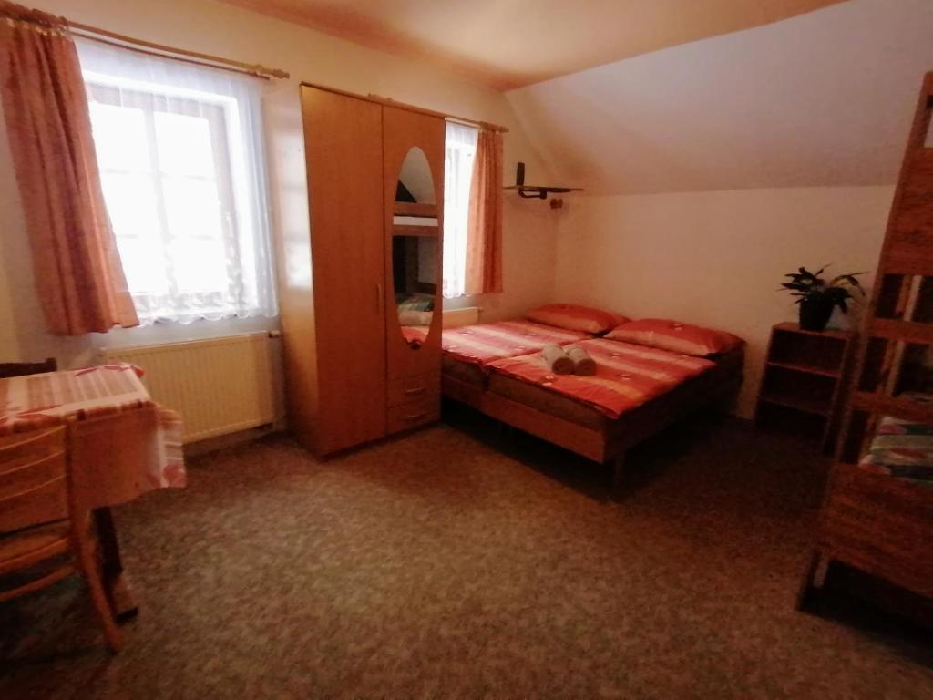 a bedroom with a bed and a large window at Apartmány 670 pod Lysou horou in Rokytnice nad Jizerou