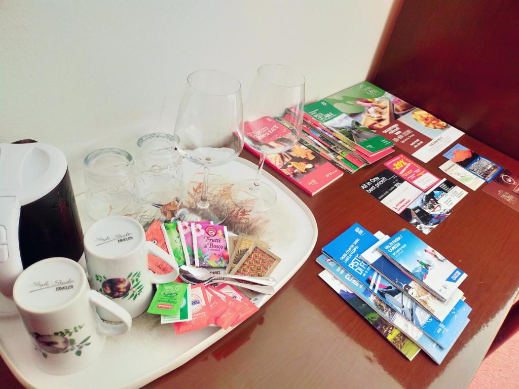 a table with wine glasses and a plate on it at Cèsa Cherpei - Dog Friendly in Campitello di Fassa