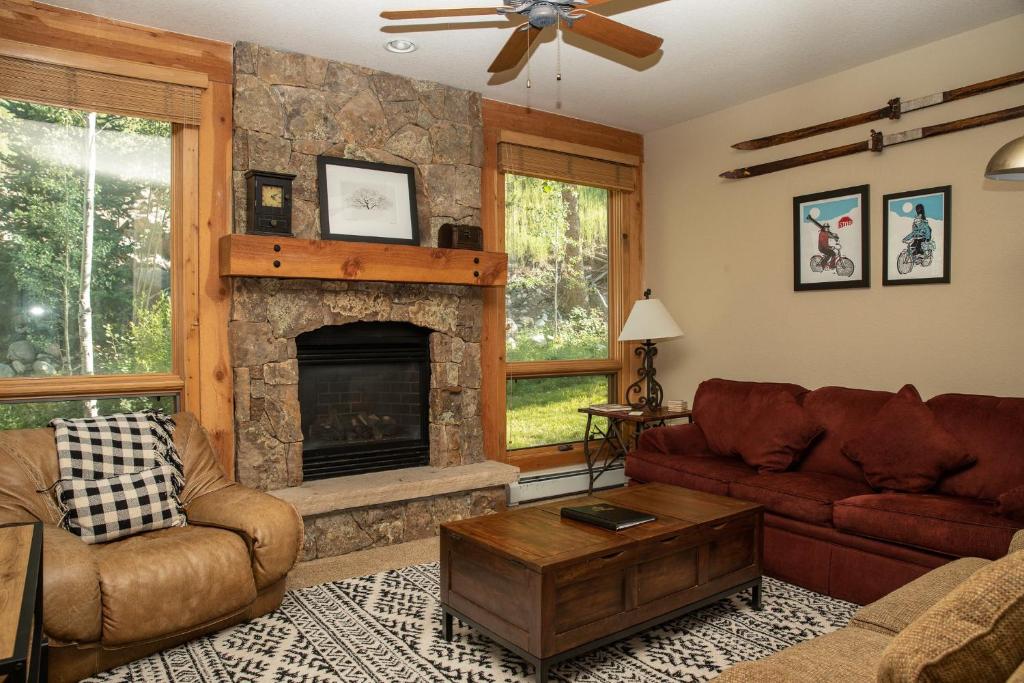 a living room with a couch and a fireplace at 6532 Settlers Creek Condo in Keystone