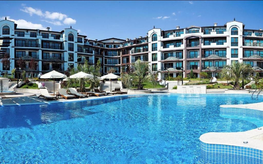 a large swimming pool in front of a large building at Boutique Rose Gardens Pomorie in Pomorie