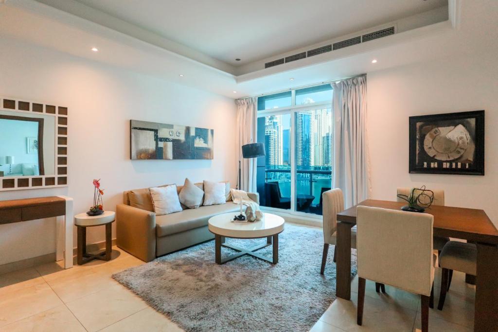 a living room with a couch and a table at HiGuests - Spacious 1BR in Dubai Marina With Amazing Views in Dubai