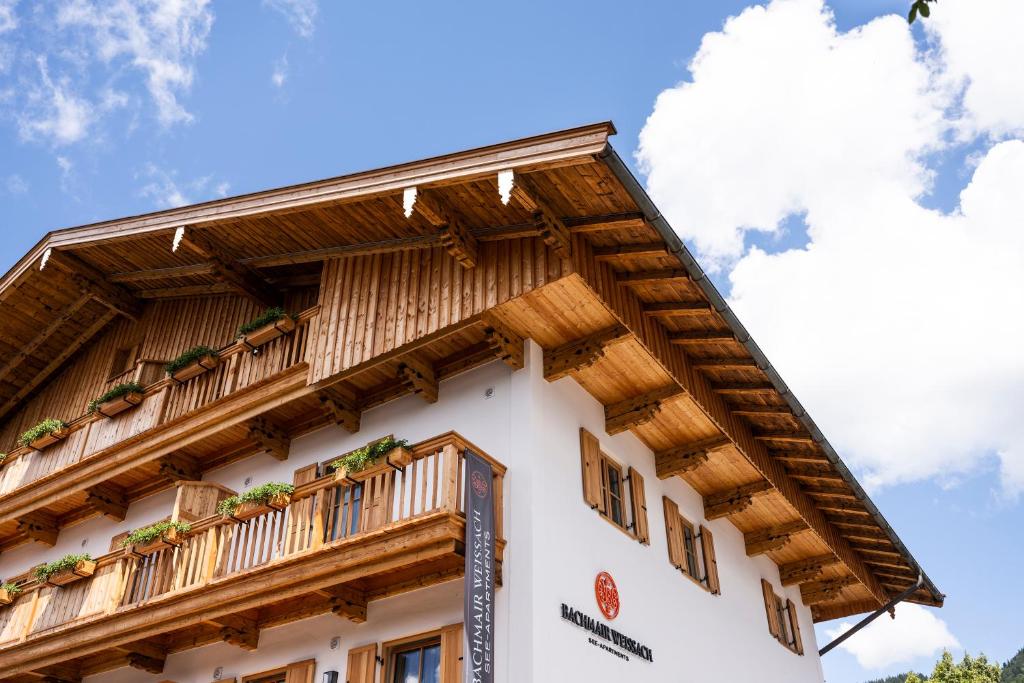 un edificio con techo de madera y balcón en Bachmair Weissach See-Apartments, en Rottach-Egern