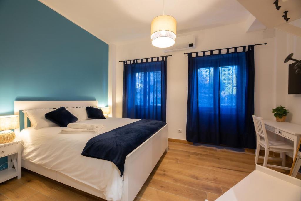 a bedroom with a large white bed and two windows at Bed & Breakfast Across The Room(e) in Rome