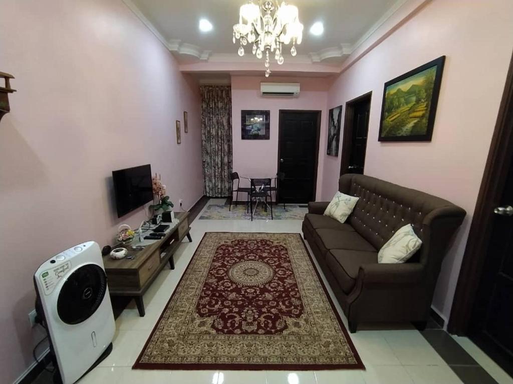 a living room with a couch and a table at Comfort Home Rawang in Rawang