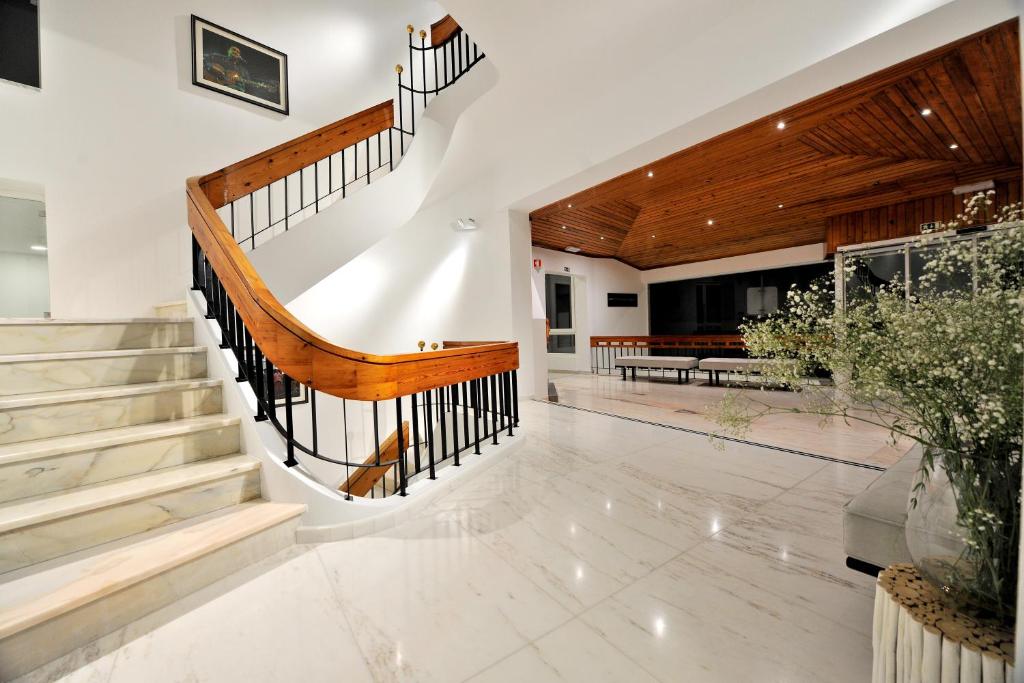 a staircase in a house with a lobby at Hotel Búzio in Sines