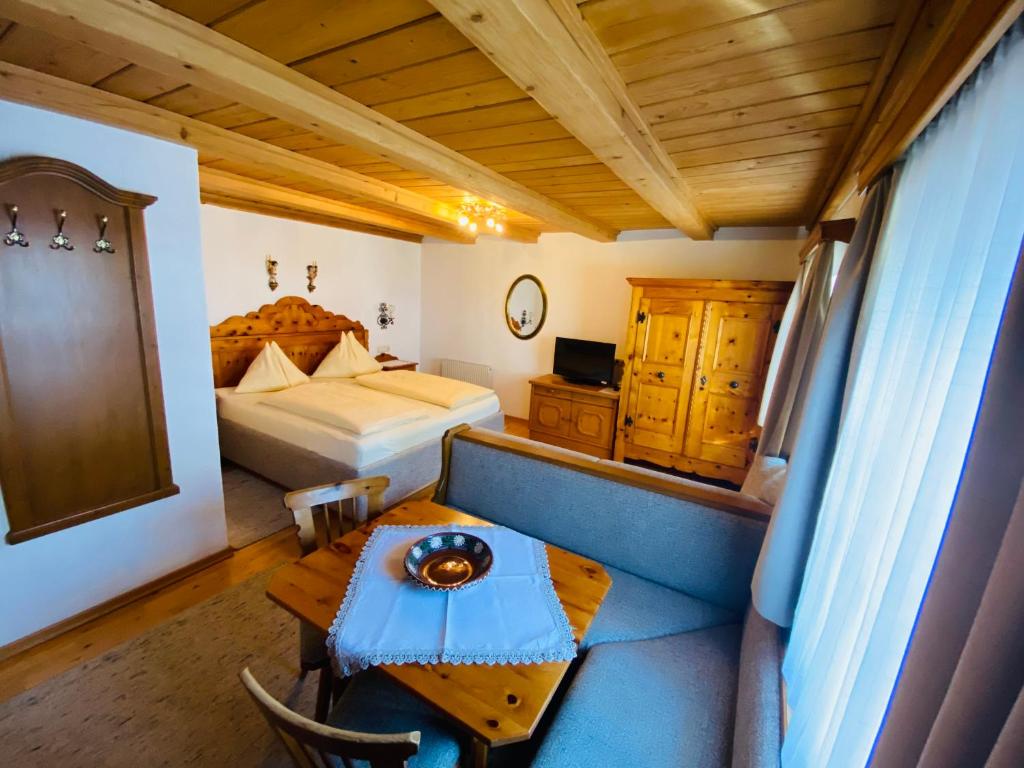 a bedroom with a bed and a table and a couch at Wengerbauer in Dorfgastein