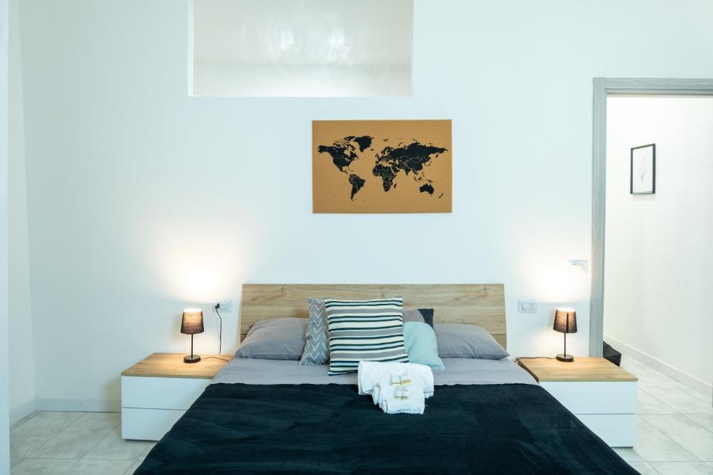 [CA 'PICO WITH WIFI]-few steps from center في ميراندولا: غرفة نوم مع سرير مع خريطة العالم على الحائط