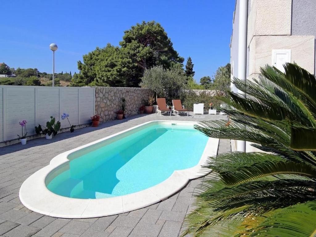 a swimming pool in the middle of a patio at Villa Vanda in Dubrovnik