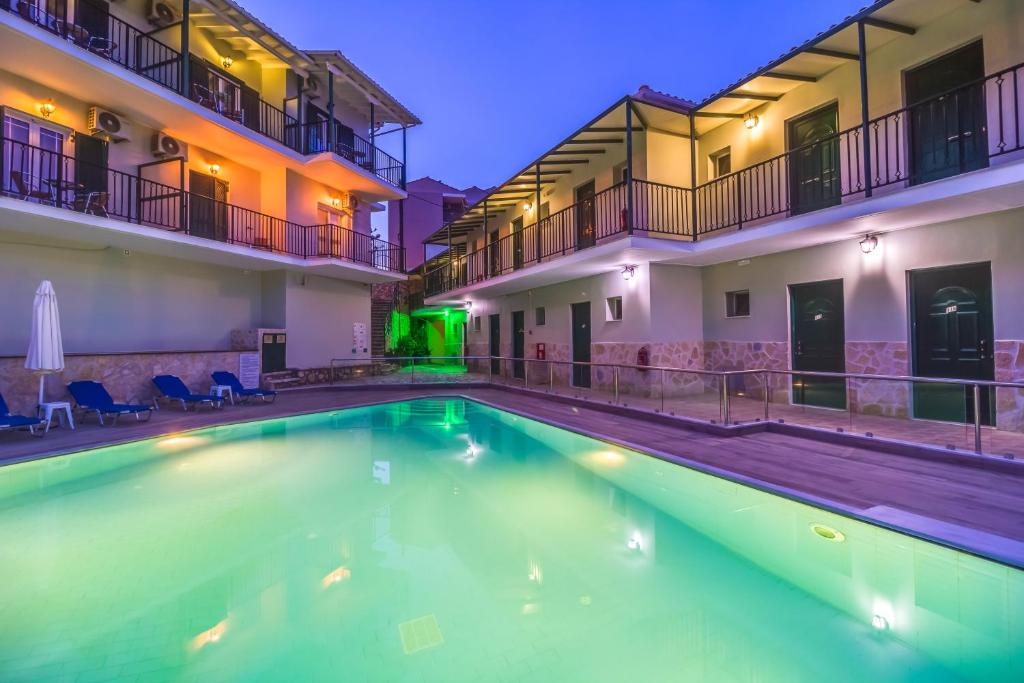 a swimming pool in the middle of a building at Vergina Star Hotel in Nikiana