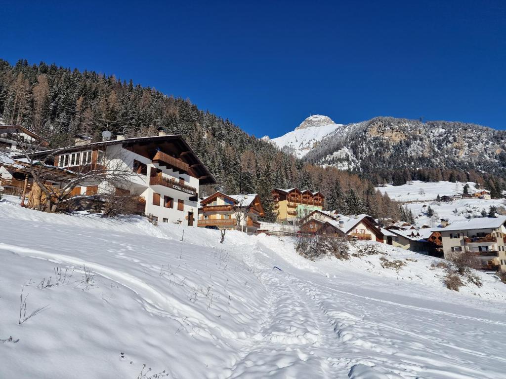 a ski lodge in the snow in a mountain at Cèsa Cherpei - Dog Friendly in Campitello di Fassa