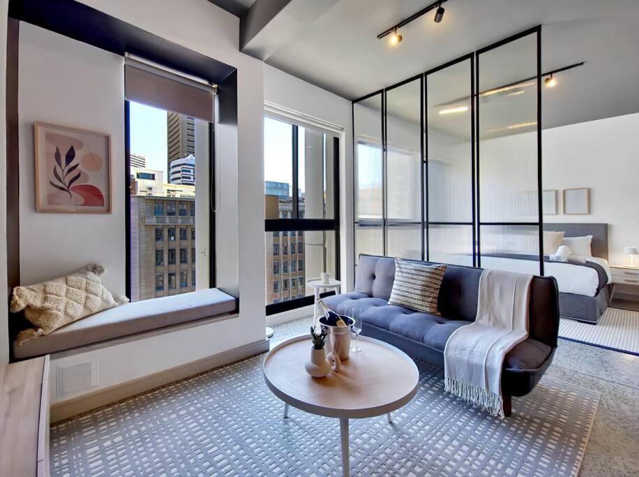 a living room with a couch and a bed at 9th floor views, couples dream- wifi-pool in Cape Town