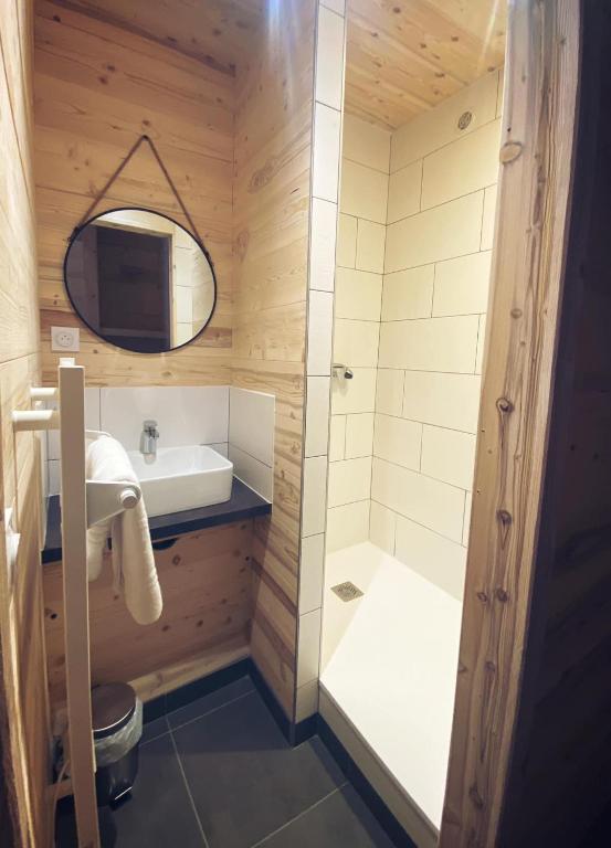 a small bathroom with a sink and a shower at Hôtel Restaurant "La Petite Auberge" in Bourg-Saint-Maurice