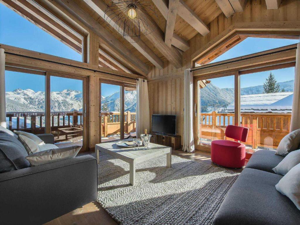 a living room with a view of snow covered mountains at Chalet Courchevel 1550, 6 pièces, 10 personnes - FR-1-562-11 in Courchevel