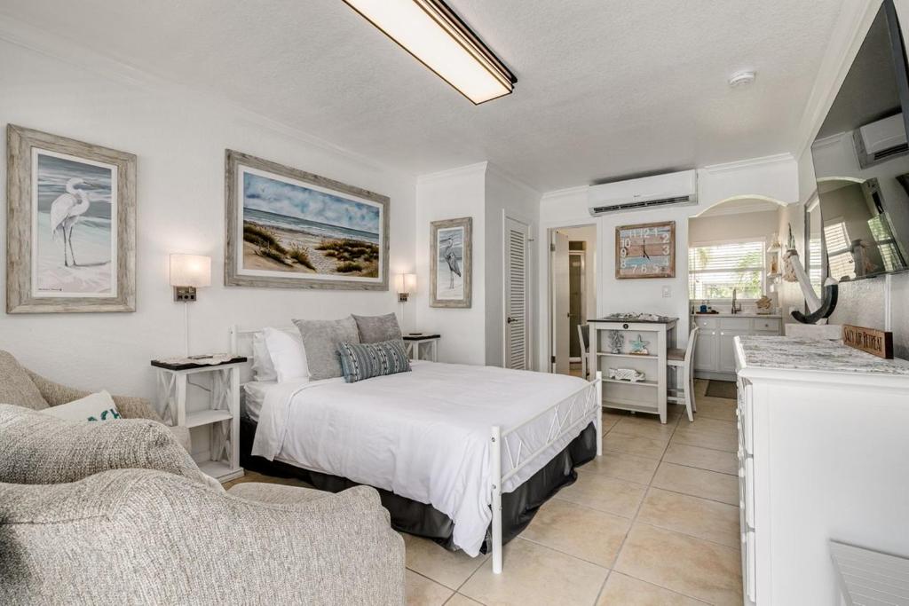a bedroom with a bed and a living room at Enjoy the Pool while being Steps from Beach and Restaurants! - Coconut Villa's Suite 6 in St. Pete Beach