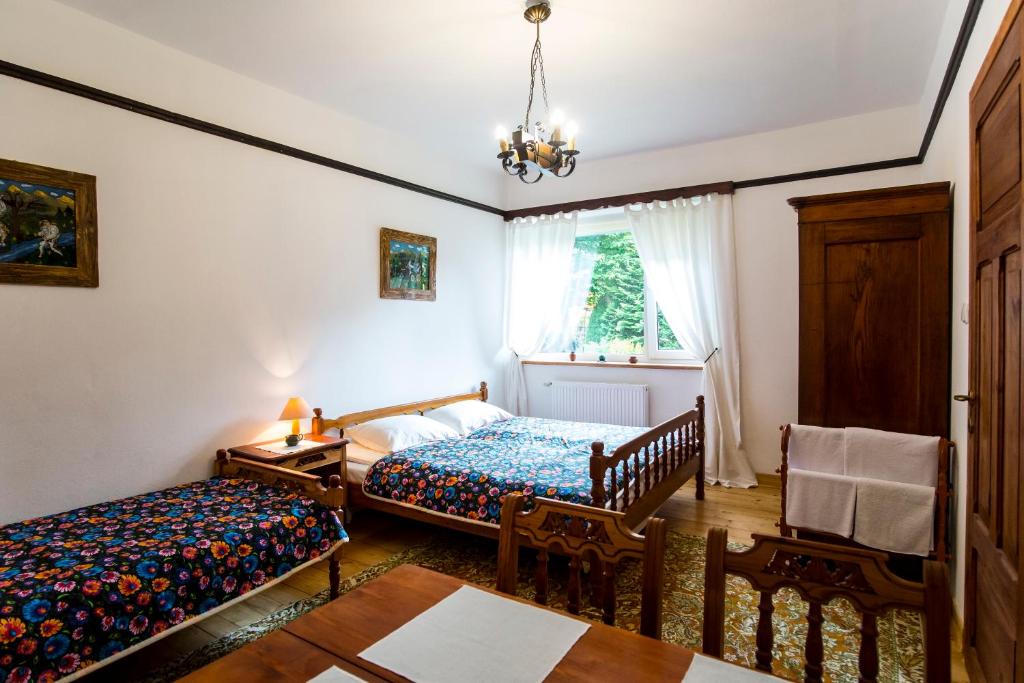 a bedroom with two beds and a window at Willa Żbikówka dom w Zakopanem in Zakopane