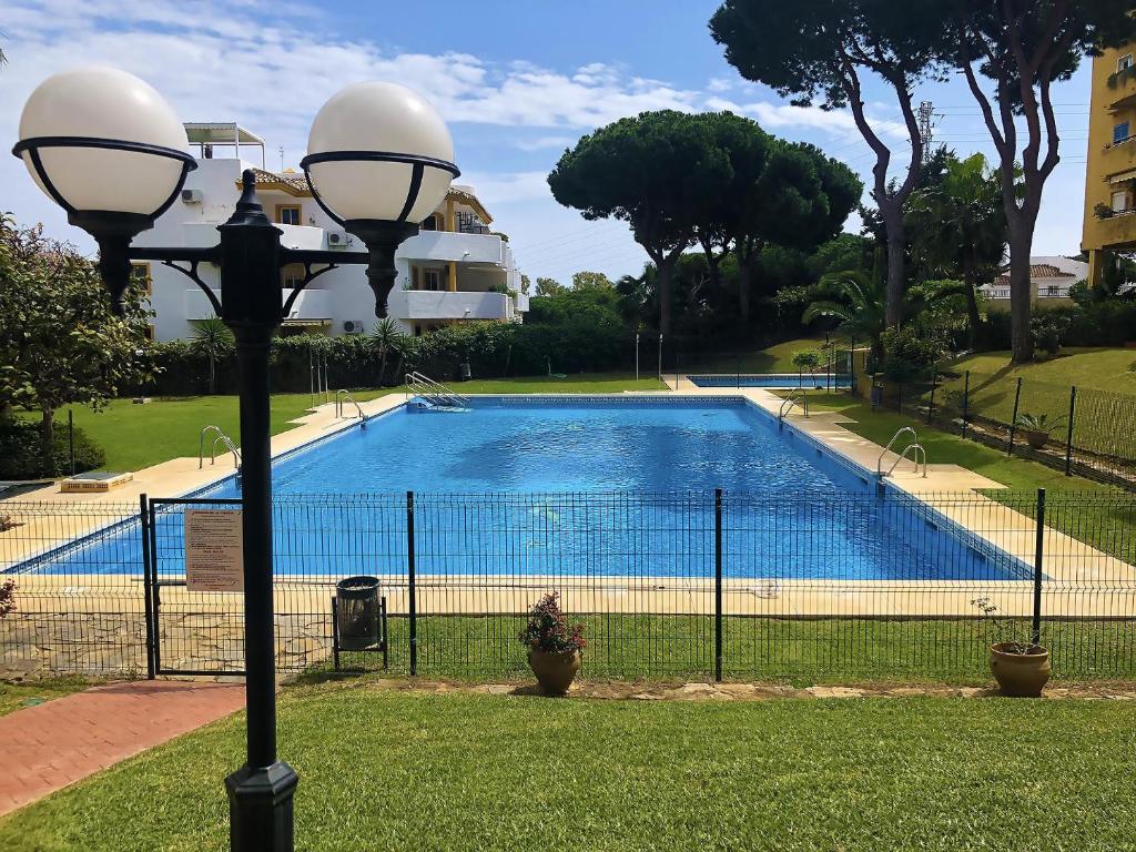 a street light next to a swimming pool at Rincon del Mar Spacios 3 bedrooms apartment close to Calahonda Beach - Mijas Costa in Mijas Costa
