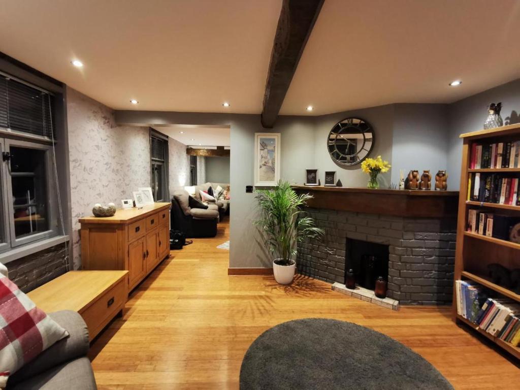 a living room with a fireplace and a couch at Riverside 2 bed apartment Bewdley Worcestershire in Bewdley