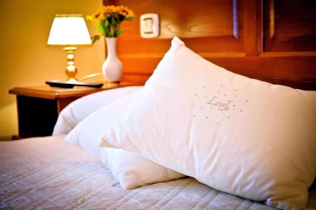 A bed or beds in a room at Relais Cavour