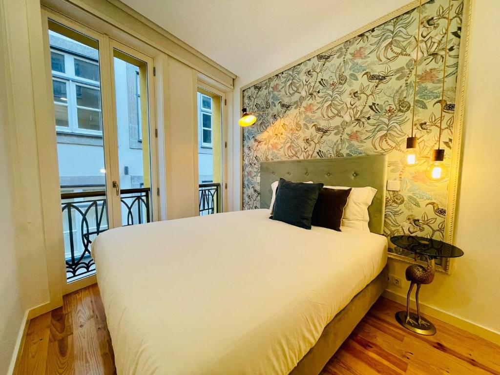 מיטה או מיטות בחדר ב-Oporto Chic & Cozy - Mercadores