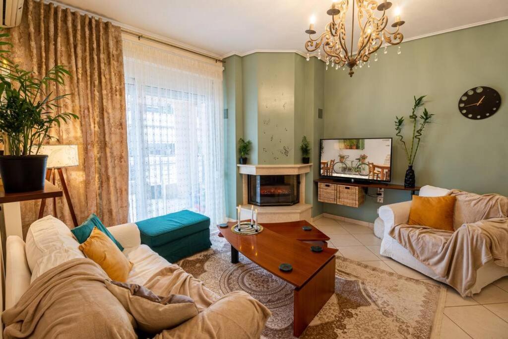 a living room with a couch and a tv at Armonia Rentals Volos Flat in Volos