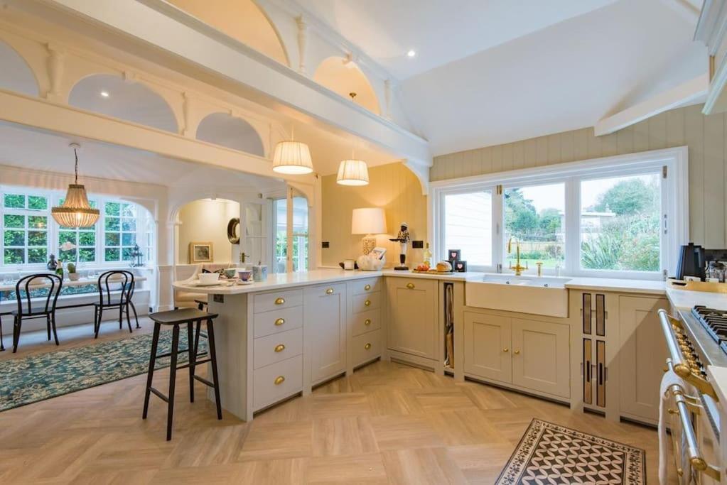 a large kitchen with white cabinets and a table at Victory at Cliffe in Kingsdown