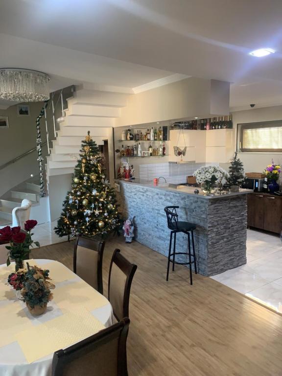 a living room with a christmas tree and a kitchen at Aisi kutaisi in Kutaisi
