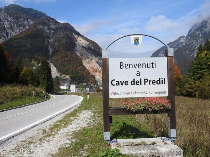 a sign on the side of a road at La Casa di Davide - David Home in Cave del Predil