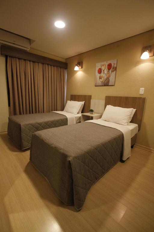 a hotel room with two beds in a room at Klein Ville Dois Irmãos in Dois Irmãos