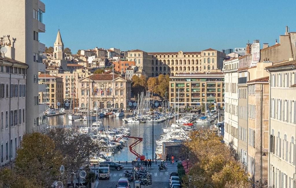 a view of a river with boats in a city at Vue sur le port superbe appartement atypique, logement entier in Marseille
