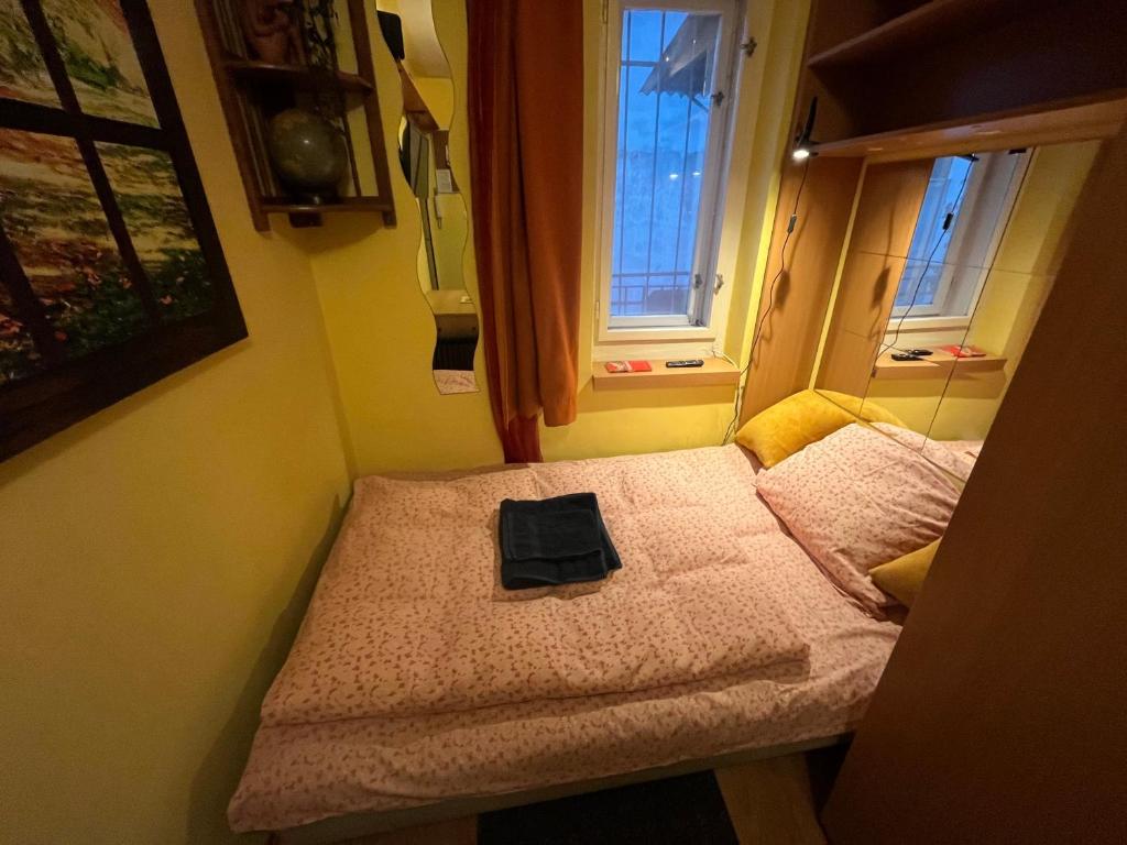 a small room with a bed with a bag on it at Tiny Private Apartment in Central Buda. in Budapest