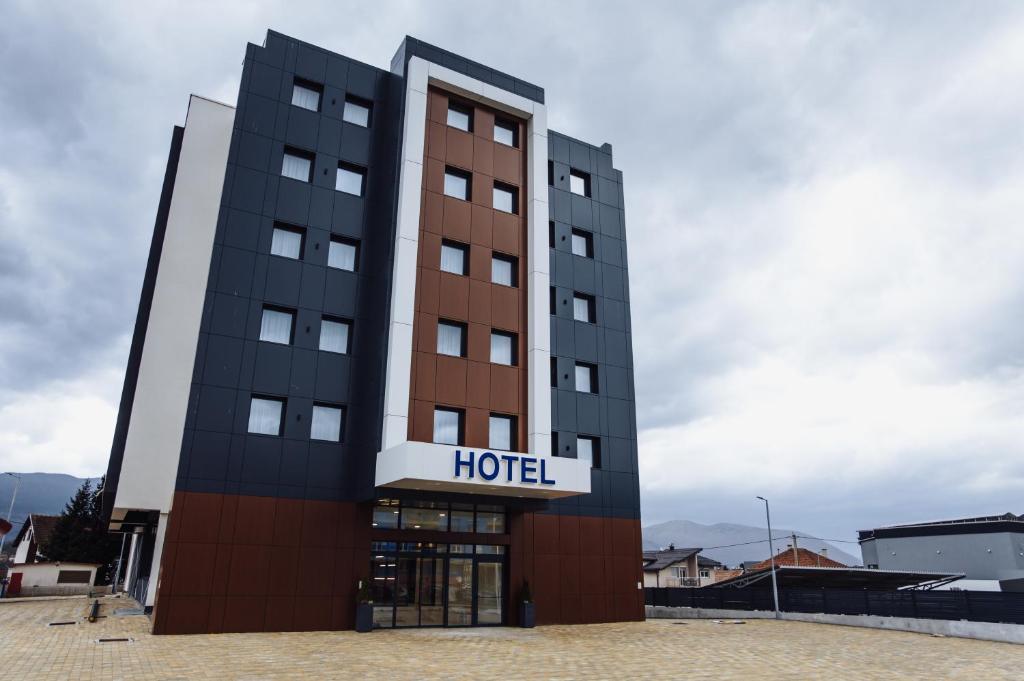 a hotel building with a hotel sign on it at Hotel Brčko gas Sarajevo in Lukavica