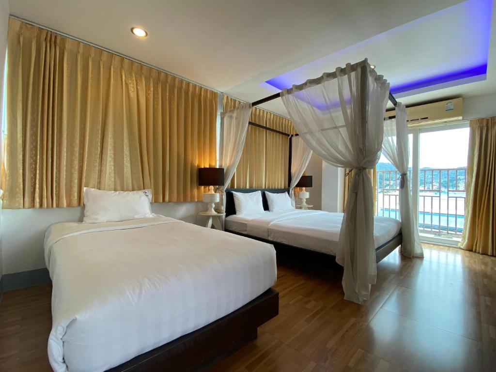 Postel nebo postele na pokoji v ubytování 77 Patong Hotel & Spa
