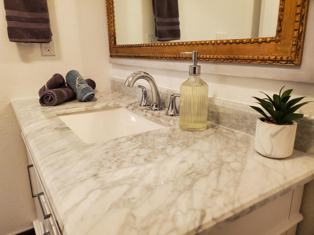 a bathroom counter with a sink and a mirror at Amazing Oasis 3 in Clovis 4 Bedrooms in Clovis