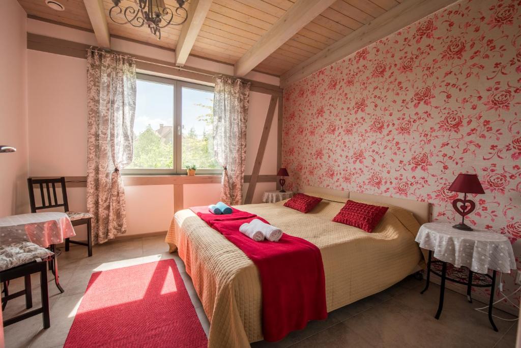a bedroom with a bed and a window at Villa Mila in Mikołajki