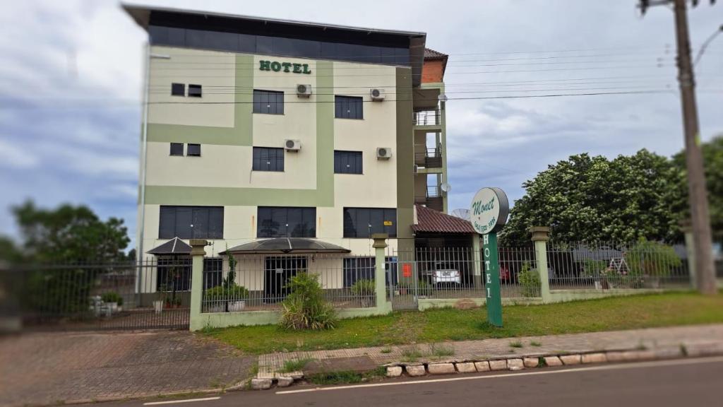 un edificio con una señal delante de él en Hotel Monet, en Erechim