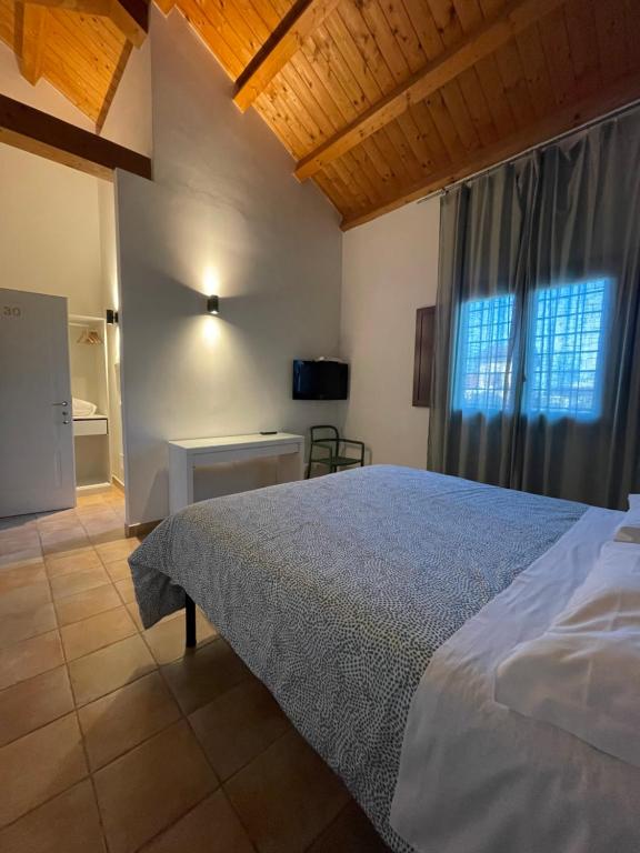 a bedroom with a large bed and a window at Luxardotel in Rome