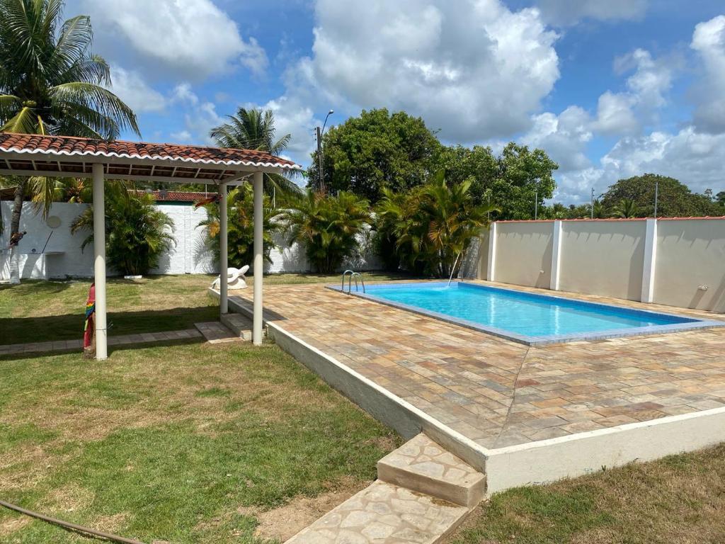 a swimming pool in the backyard of a house at Beach House Peroba in Maragogi