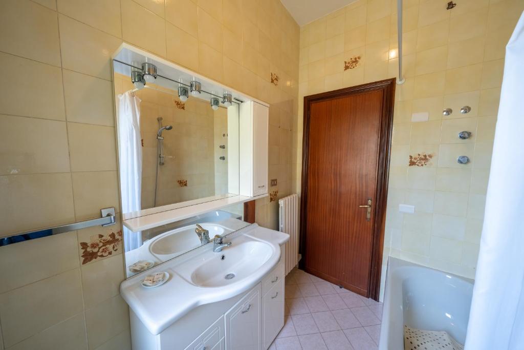 a bathroom with a sink and a mirror and a tub at Il Rifugio Del Merlo in Amalfi