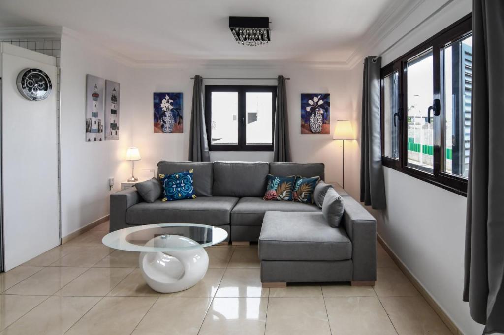 a living room with a couch and a table at CASA CUADERNA a 150 metros de la playa in Playa Honda