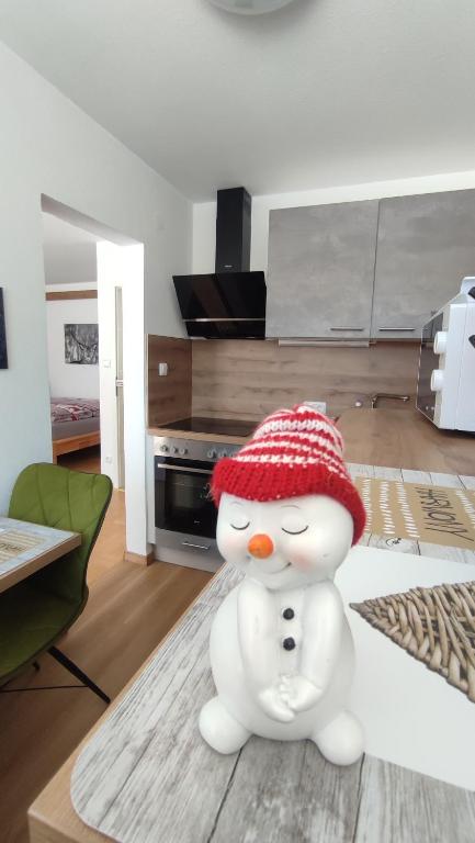 a toy snowman sitting on a table in a living room at Fewo Gabriela Allgäu in Immenstadt im Allgäu