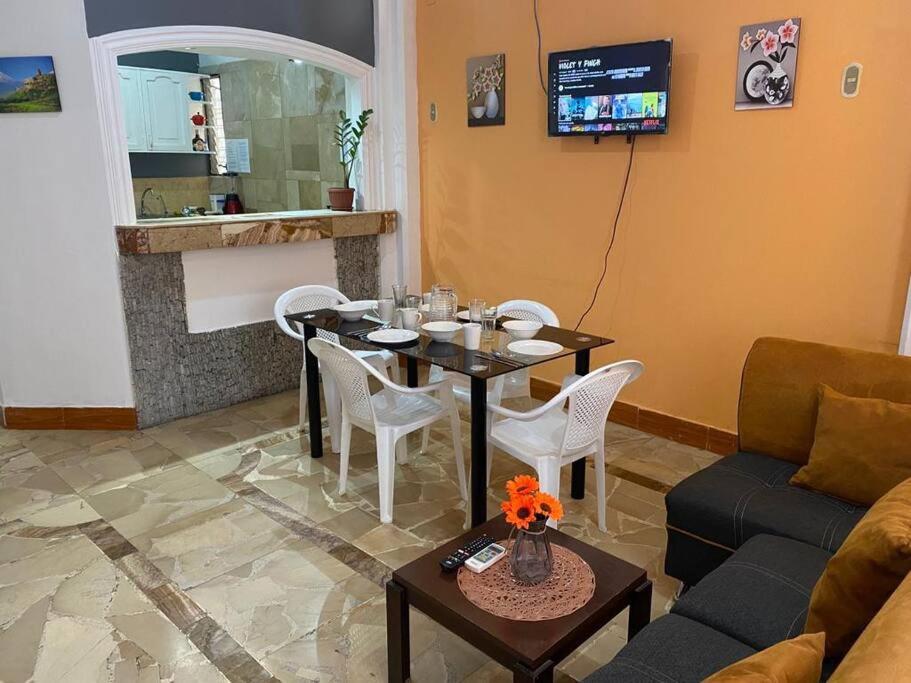 sala de estar con mesa y sofá en Dpto En GARZOTA a 5 Mnts del Aeropuerto, en Guayaquil