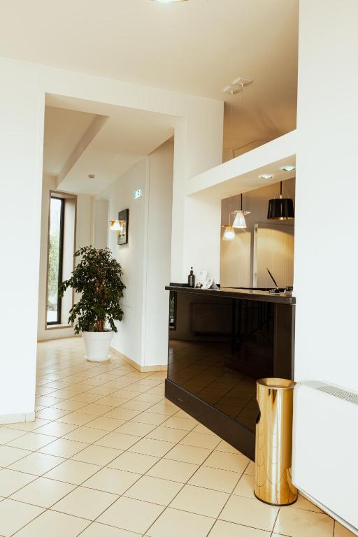 a large kitchen with a counter and a table at Tuo Hotel in Polignano a Mare